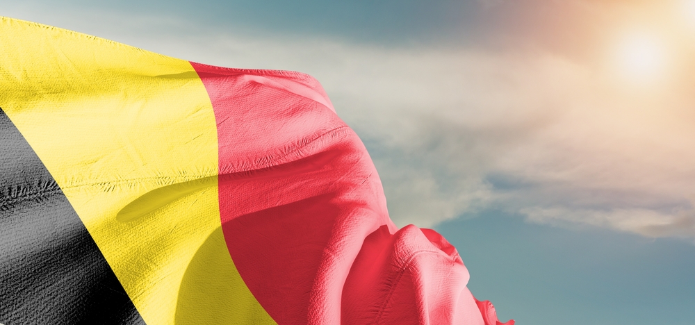 Belgium,National,Flag,Cloth,Fabric,Waving,On,Beautiful,Grey,Sky