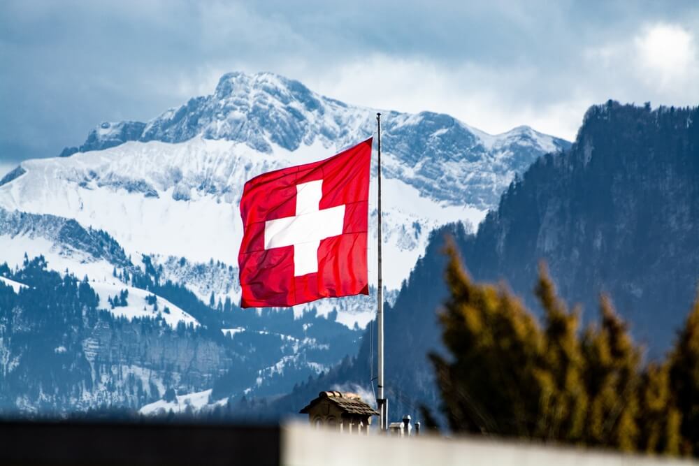 Bright,Red,Swiss,Flag,Blowing,In,The,Wind,With,Swiss